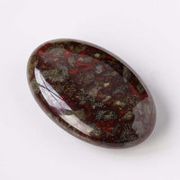 Natural crystal hot compress oval stone with red and dark patterned surface
