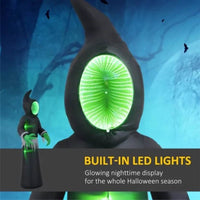 Halloween inflatable ghost with LED lights and eerie green face in a spooky graveyard setting with pumpkins and moonlight