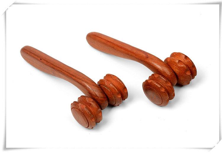 Hand holding rosewood two-wheel massager with rolling wheels for massage