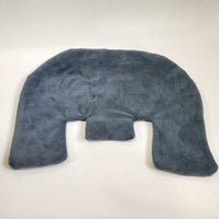 Woman using electric heating shoulder guard neck wrap for pain relief at home