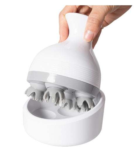 White handheld head massager with silicone kneading nodes and charging base