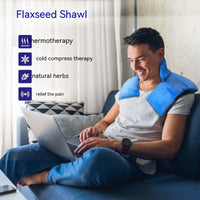 Man using blue flaxseed gravity neck shoulder pad for pain relief while working on laptop