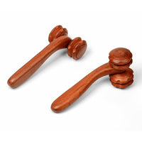 Hand holding rosewood two-wheel massager with rolling wheels for massage