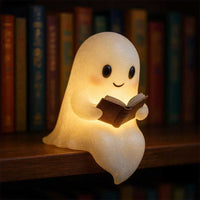 Cute ghost night light with warm LED glow holding a book, perfect for kid's bedroom or Halloween decor