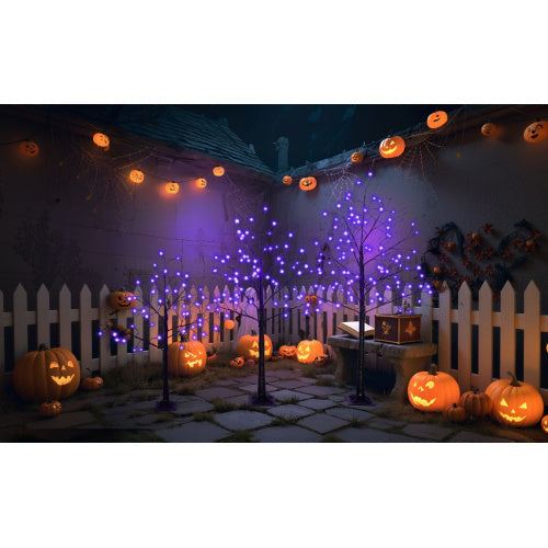 Three Halloween spooky trees with purple LED lights in a dark outdoor setting surrounded by jack-o'-lanterns and pumpkin decorations