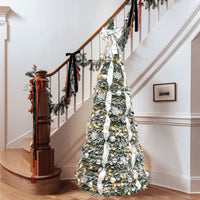 6ft Christmas Tree decorated with white ribbon, silver balls, and snowflake ornaments next to staircase railing with garland decoration