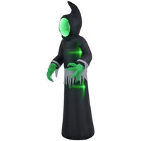 Halloween inflatable ghost with LED lights and eerie green face in a spooky graveyard setting with pumpkins and moonlight