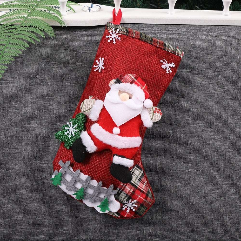 Red Christmas stocking with Santa Claus and snowflake decorations hanging on railing Christmas decorations