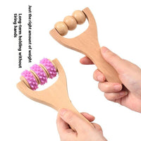 Woman using wooden portable roller foot meridian massage with three beads for stress relief and skin relaxation