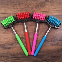Telescopic plastic massage rollers with colorful handles and multiple roller beads on wooden background