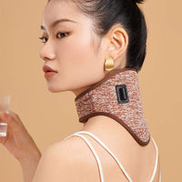 Woman wearing electric heating neck massage belt with USB power plug on beige background